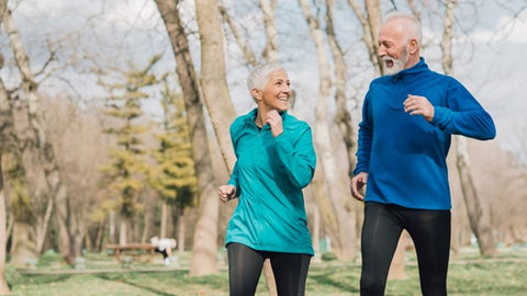 Senior couple walking outdoors.