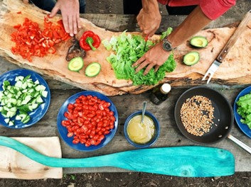 Two people preparing a healthy and fresh meal.