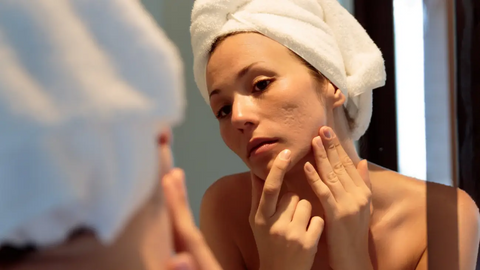 Woman touching her face skin