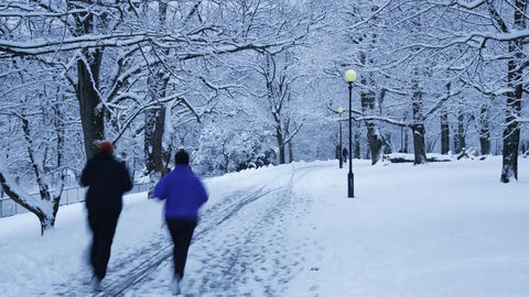 People walking in winter surrounded by snow