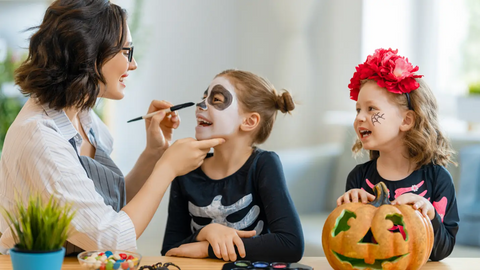 Mom painting daughter's face