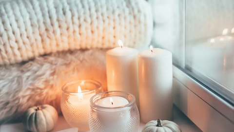 Cozy environment with candles and blankets