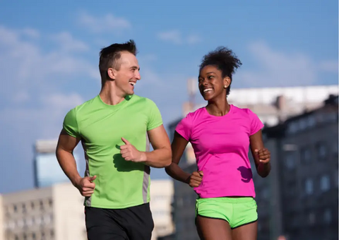 A couple running and smiling at each other