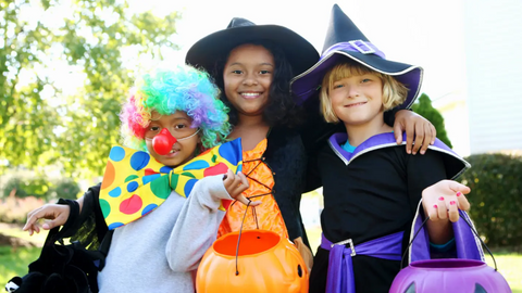 Group of kids hugging and smiling on Halloween