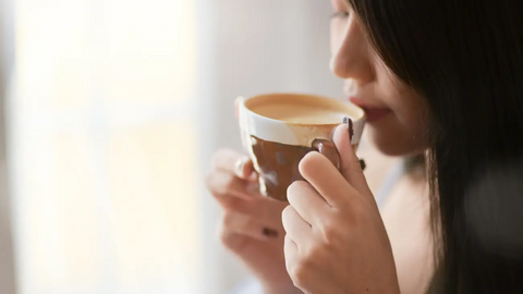 Woman sipping on coffee