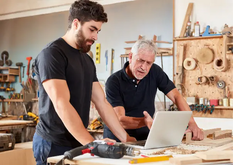 Man learning from his mentor at work