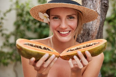 Woman holding a papaya