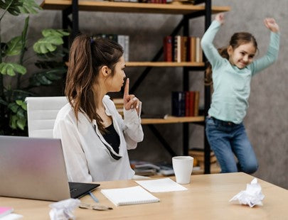 Mother telling her daughter to be quiet while working