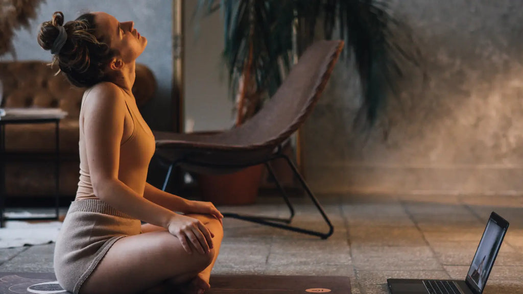 Woman practicing yoga following online video