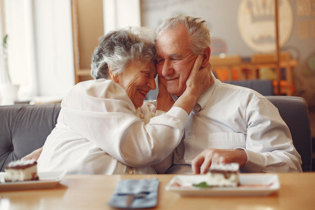 Senior couple hugging and laughing.