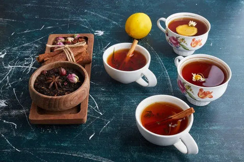 Cups of tea with cinnamon and lemon